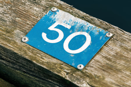 Nissan river wooden quay numeration plates in Halmstad, Sweden. Number 50 with selective focus.の写真素材