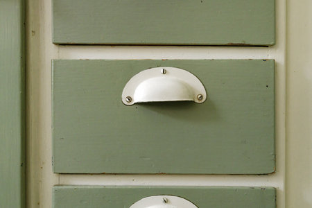 Old vintage wooden kitchen cabinet drawers and handlesの写真素材