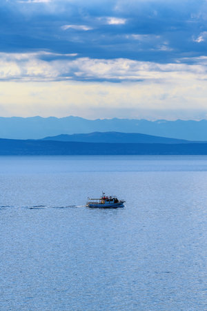 Fishing boat dinghy sailing at sea water of Kvarner gulf in Croatia, selective focusの写真素材