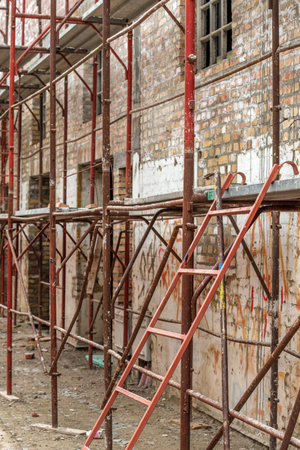 Scaffolding structure on construction site, renovation of an old industrial building, selective focusの写真素材