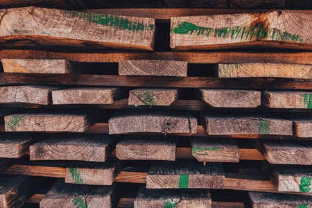 Stack of wooden planks solid-sawn timber construction material as backgroundの写真素材