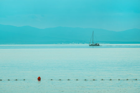 Yacht sailing across the Kvarner gulf of Adriatic sea in Croatia on overcast rainy morningの写真素材