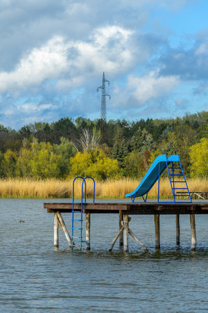 Toboggan slide on lakeside pier, selective focusの写真素材
