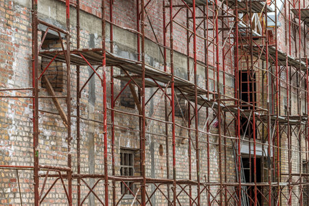 Scaffolding structure on construction site, renovation of an old industrial building, selective focusの写真素材
