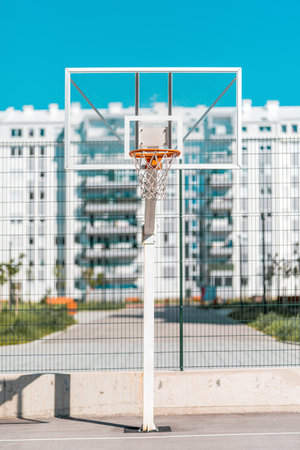 Transparent plexiglass basketball backboard with hoops on outdoor court for streetball in urban residential district, selective focusの写真素材