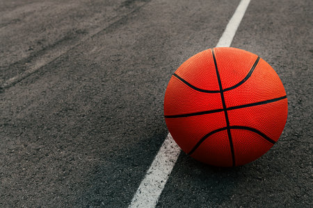 Basketball ball on outdoor court with asphalt surface, selective focusの写真素材