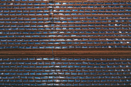 Top down aerial shot of watermelon plantation with plastic sheeting hothouse equipment, drone pov