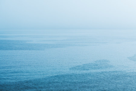 Summer shower rain at Croatian Adriatic sea shoreline, minimalistic landscape background with raindrop patternの写真素材