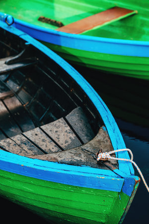 Green rowing boats tied to pier, selective focusの写真素材