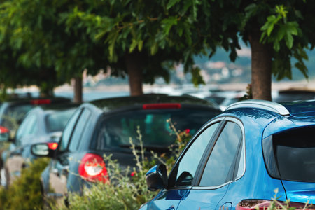 Parked cars on parking lot with trees, selective focus