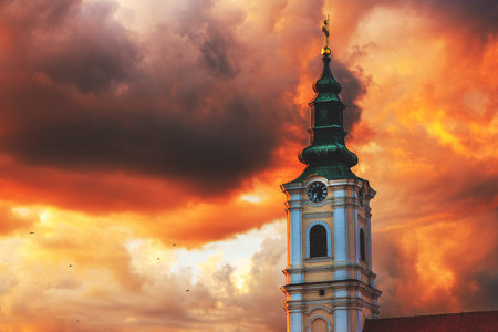 Dormition church tower in Novi Sad, Serbia. Beautiful orthodox religious building in summer sunset. Selective focus.の写真素材