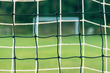 Soccer goal net against green grass background, selective focusの写真素材