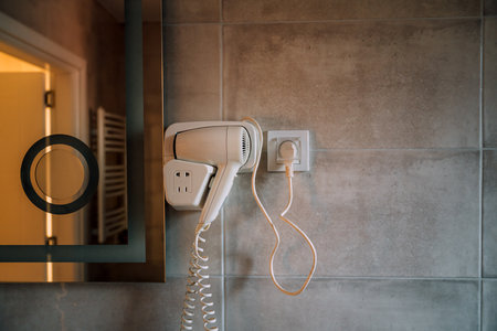Hair dryer and mirror in bathroom, selective focusの写真素材