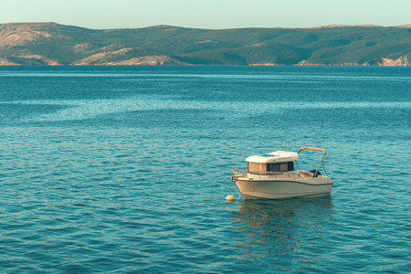 Fishing boat floating on water close to the Adriatic sea shoreline in Kvarner bay, selective focusの写真素材