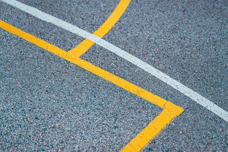 Outdoor basketball court lines and markings on concrete flooring, street ball abstract background, selective focusの写真素材