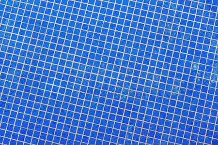 Small blue ceramic tiles in outdoor fountain pool as background and pattern