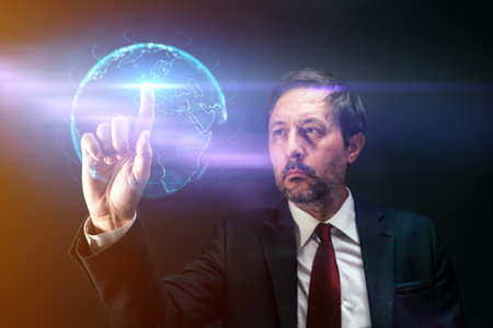 Businessman pushing virtual screen interface display with earth map, selective focusの写真素材