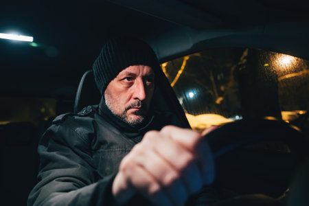 Man driving car at cold winter night, selective focus