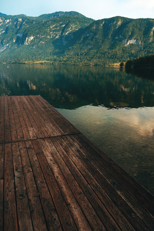 Wooden wharf pier at lake Bohinj in summer morning, selective focus