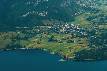 Aerial shot of Stara Fuzina, beautiful scenic alpine village in Lake Bohinj Valley in Slovenia, high...