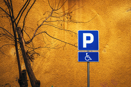 Accessible parking space sign against vibrant yellow wall, copy space includedの写真素材