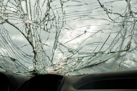 Broken glass texture, car windshield after traffic accident, shattered glass material background,...