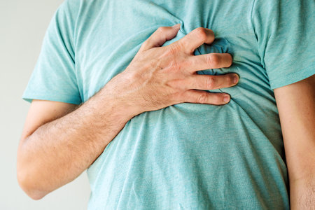 Heartache, chest pain and heart attack concept. Man with painful symptoms of a heart disease....