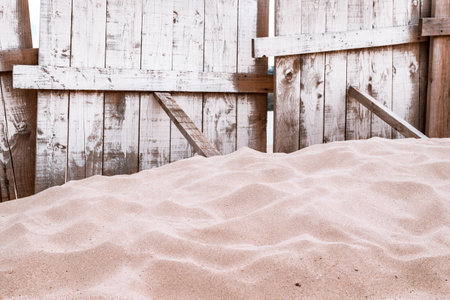 Wooden plank fencing and sand pile on Danube river beach, selective focusの写真素材