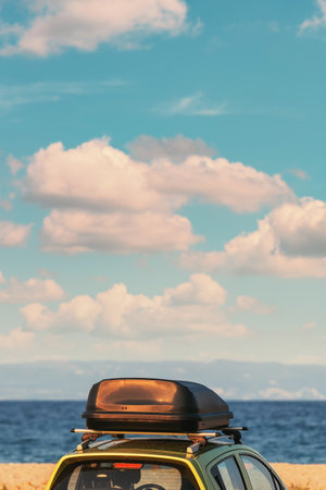 Car roof box on vehicle parked at seaside beach in summer, travel and holiday vacation concept, selective focusの写真素材