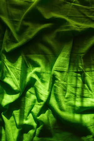 Wrinkled bed sheets as background, top view of crumpled green bed linen textureの写真素材