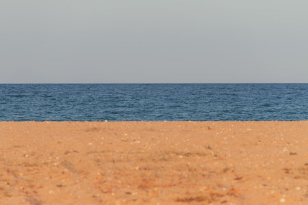 Seascape background, sandy beach and clear sky, selective focusの写真素材