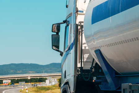 Trucking and freight transportation background image, large cistern truck on the road in summer, selective focusの写真素材
