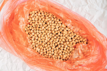 Plenty of chickpea in a plastic bag, top view with selective focus