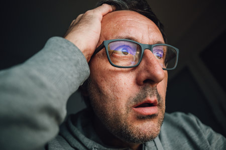 Bad shocking news found on internet, closeup portrait of adult male looking at computer screen,...