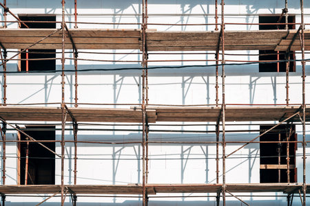 Old rusty scaffolding surrounding building structure, selective focusの写真素材