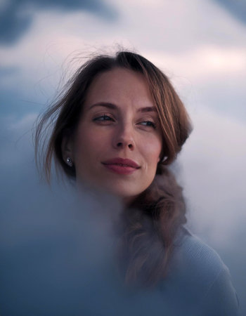 Dreamy portrait of beautiful young woman in clouds, generative aiの素材