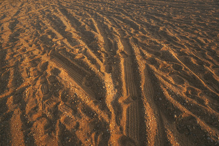 Tire track tread marks in sandy dust road, selective focusの写真素材