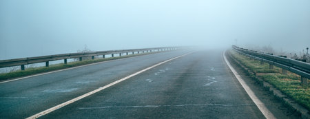 Empty countryside road in foggy winter morning, selective focusの写真素材