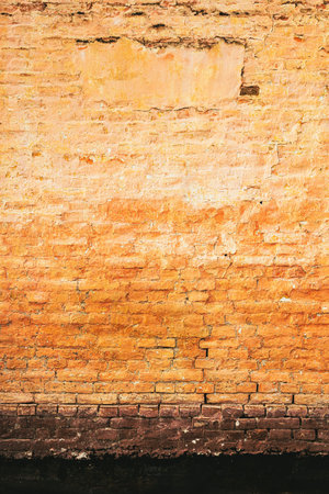 Old worn cracked brick wall, vertical image