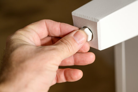 Man assembling furniture at home for a DIY project, selective focus