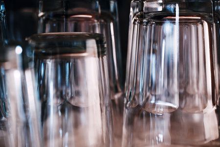 Set of empty clean drinking glasses on kitchen counter top after washing, selective focusの写真素材