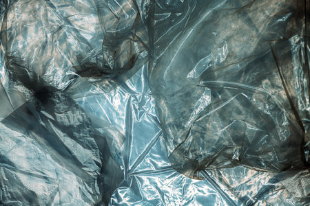 Texture of glossy polyethylene plastic sheet material crumpled and wrinkled from aboveの写真素材