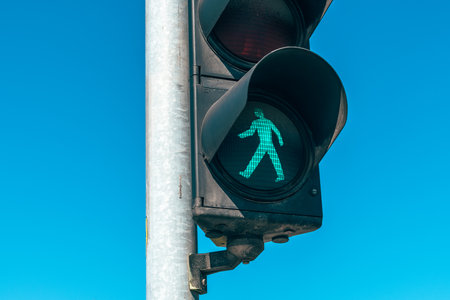 Green light, pedestrian stop light closeup on the street, selective focus