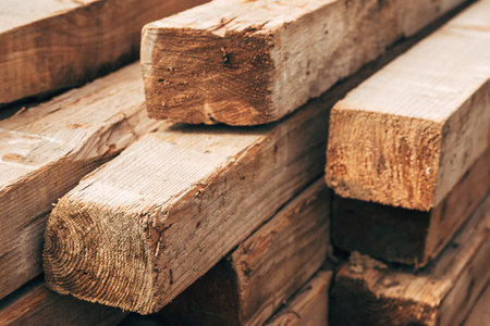 Pile of stacked timber wood on a site, selective focus