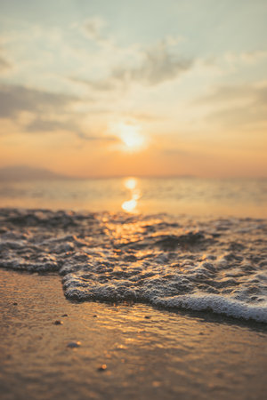 Closeup of sea foam in summer sunrise at Aegean sea, selective focus