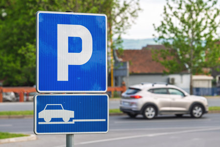 Car parking sign on the street with vehicle in background, selective focusの写真素材