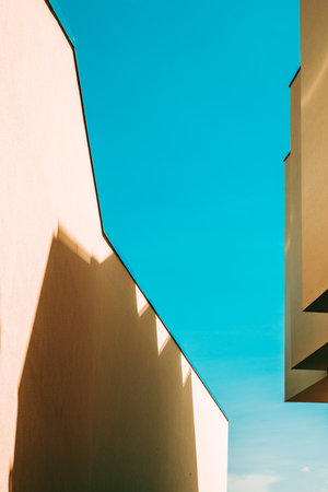 Architectural pattern, modern residential building facade with shadow and light, minimalistic composition as backgroundの写真素材
