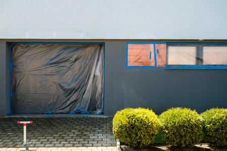 House renovation, protected doors and windows for building repainting, selective focusの写真素材