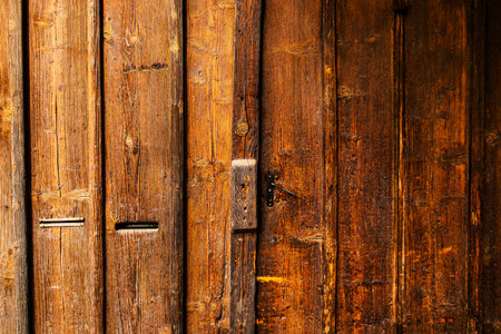 Rustic wooden gate detail as background, weathered surface of massive entrance doorwayの写真素材
