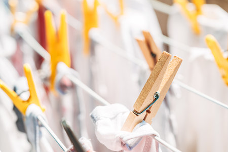 Clothespins on clothes drying rack, closeup with selective focusの写真素材